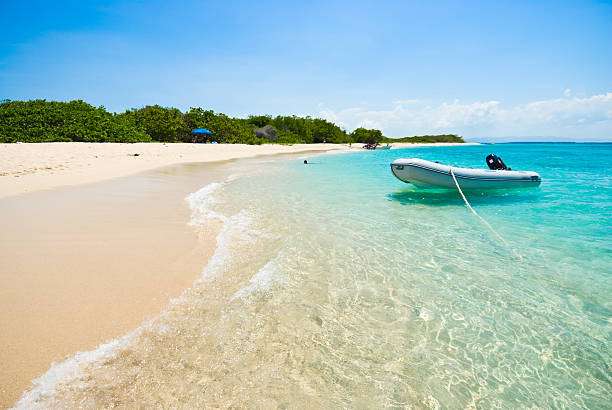 istock Tropical island beach with a boat 97893192