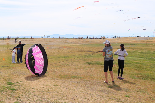 Garry Point Park. June 2018. Richmond, British Columbia Canada. The annual Kite Festival with kite displays, demonstrations, kite making workshops for kite lovers of all ages. Beginner and advanced kite flyers are showing their skills.