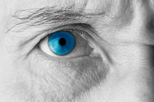 Close-up of senior man’s blue eye.