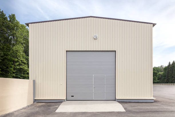 istock industrial storehouse with closed gray metal gate 978949446
