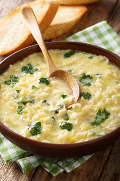 istock Italian egg soup stracciatella with farfalline pasta and parmesan close-up. vertical 978952224