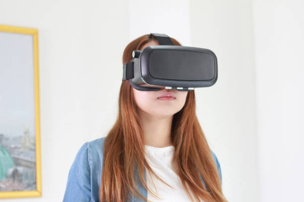 istock Young woman wearing virtual reality glasses at home. 978958006