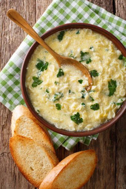 istock Italian food: soup stracciatella with farfalline and cheese close-up. Vertical top view 978958102
