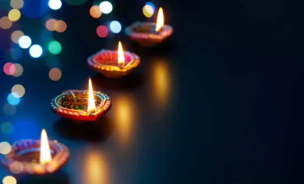 Colorful Diya lamps with bokeh lights background