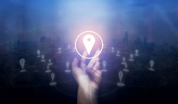 istock Hand holding location pin map icon and network connection on city of screen. Innovation technology concept. 978961096