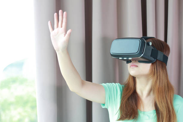 istock Young woman wearing virtual reality glasses at home. 978961802