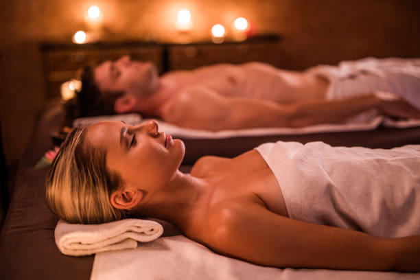 istock Young relaxed couple lying on massage beds at the spa. 978961856