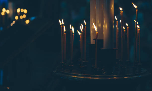 istock lighted candles in the church 978964136