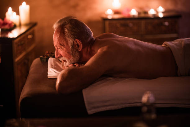 istock Smiling senior man relaxing on a massage bed at the spa. 978964448