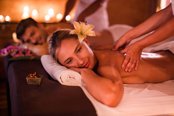 istock Young couple enjoying in back massage at health spa. 978964608