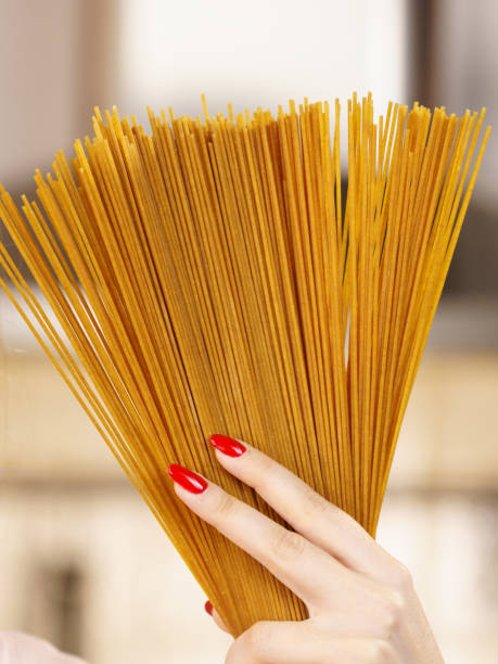istock Woman hand holding pasta 978969698