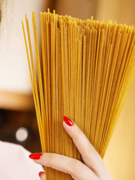 istock Woman holding long pasta 978969908