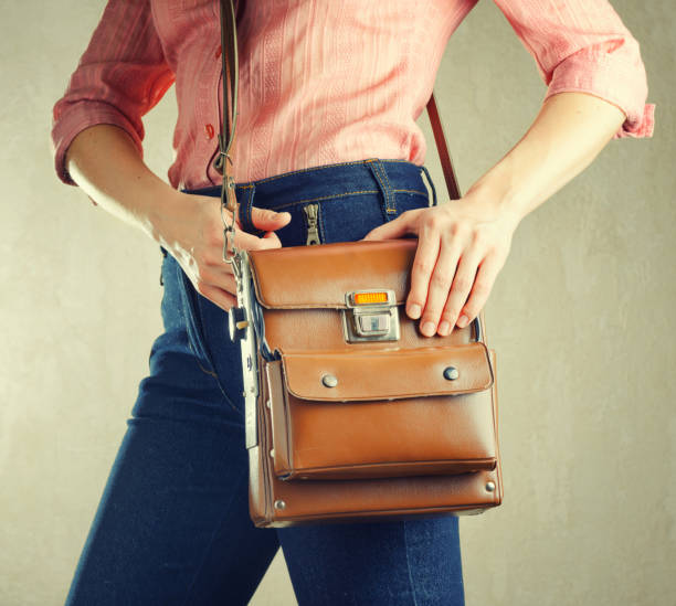 istock Young woman in deep blue jeans holding a bag 978985700