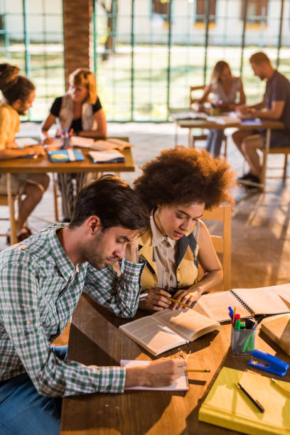 istock College students sitting together at the table and studying for the exams. 978985798