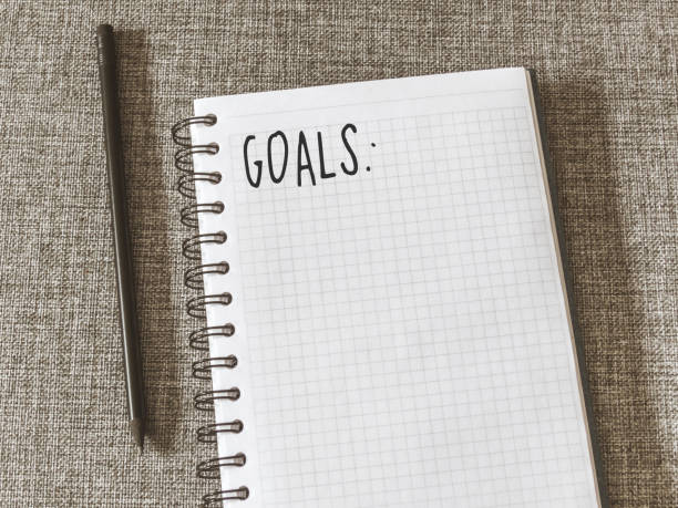istock Top view goals list with notebook, pencil on fabric. Flat lay, copy space 978985964