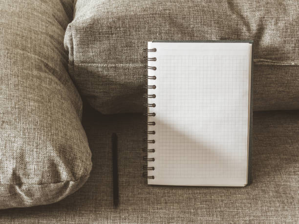 istock Top view goals list with notebook, pencil on grey fabric. Flat lay, copy space 978986008