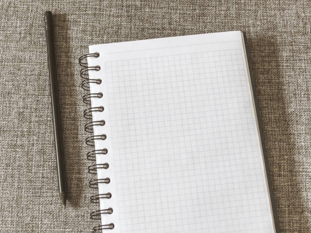 istock Top view goals list with notebook, pencil on grey fabric. Flat lay, copy space 978986020