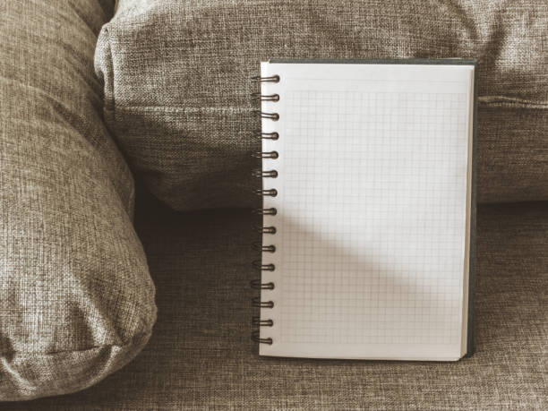 Top view goals list with notebook, on grey fabric. Flat lay, copy space