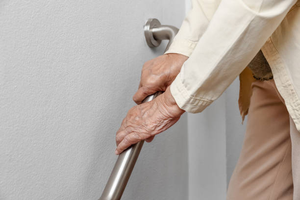 Elderly woman holding on handrail for safety walk steps Elderly woman holding on handrail for safety walk steps gripping bars stock pictures, royalty-free photos & images