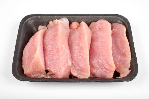 istock Raw dietary turkey meat pieces in tray, isolated on white background 978992346