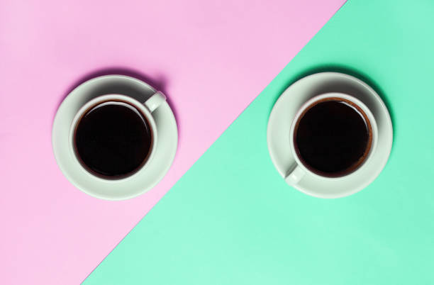 istock Two cups of coffee on minimalistic blue and pink background. 978992710