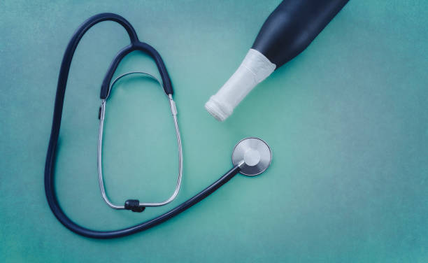 istock Stethoscope with bottle of alcohol on green background 978996874
