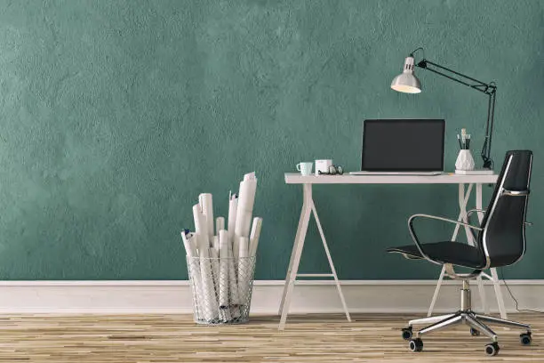 Workdesk with decoration on hardwood floor in front of empty teal wall with copy space. 3D rendered image.