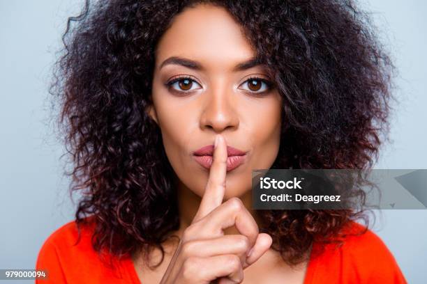 Shh Closeup Portrait Of Mysterious Charming Woman With Modern Hairdo Asking For Keeping Silence Holding Forefinger On Plump Lips Isolated On Grey Background Stock Photo - Download Image Now