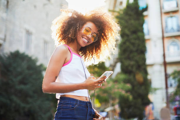 istock Beautiful young woman with afro, summer time. 979000306
