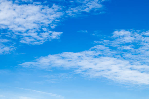 Cloudscape against deep blue sky. - fotografia de stock