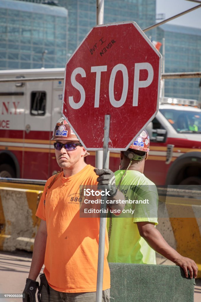 Avoid. Sign Workers Construction Workers With A Stop Sign Stock Photo - Download Image Now ...