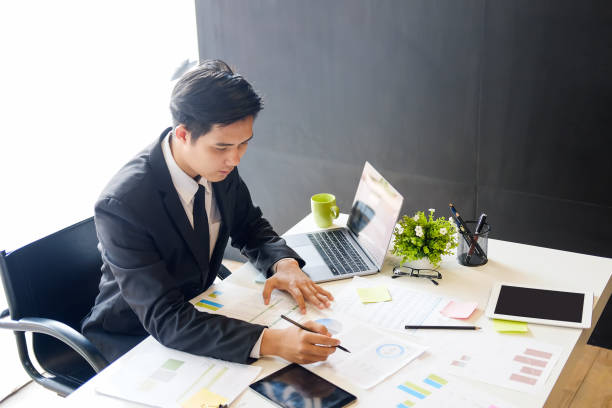 istock Asian businessman on workplace in office. 979006400