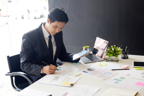 istock Asian businessman on workplace in office. 979006536