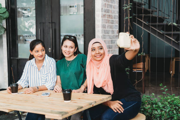 istock Happy multi ethnic friends doing a selfie together with instant camera 979008844
