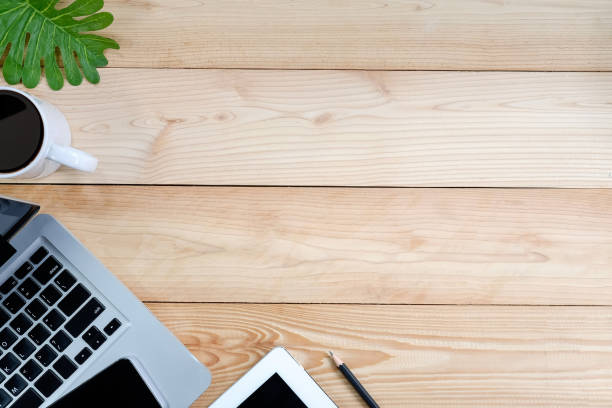 istock Workspace with laptop, tablet, smartphone and coffee cup on wooden desk. 979008966