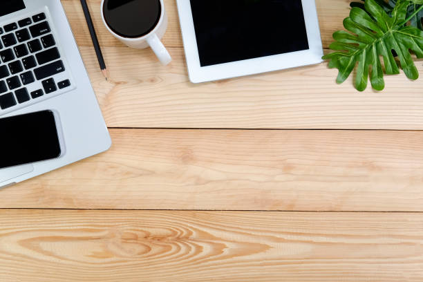 istock Workspace with laptop, tablet, smartphone and coffee cup on wooden desk. 979009102
