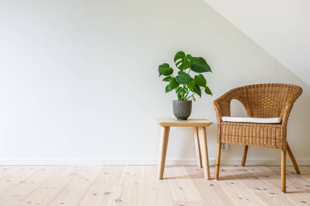 rattan armchair with a wooden table with a potted plant - scandic imagens e fotografias de stock