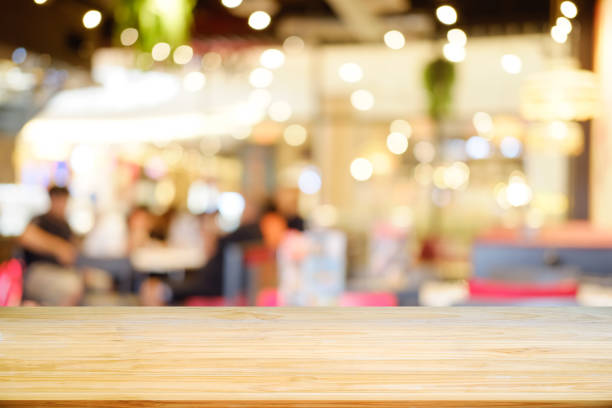 istock Wooden table on blurred cafe in background. 979009810