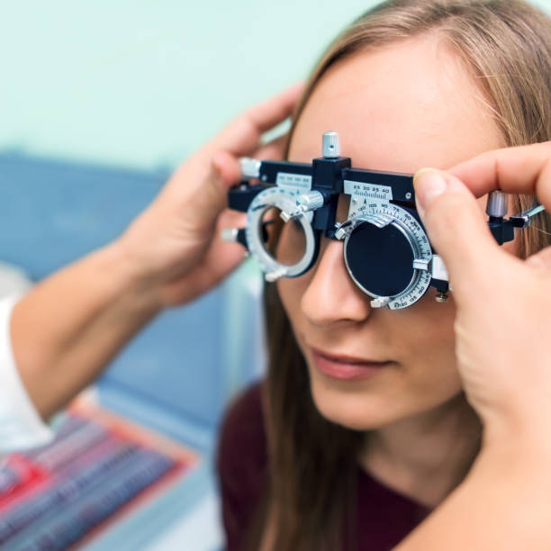 istock Young woman having her eyes checked at ophthalmologist 979012652
