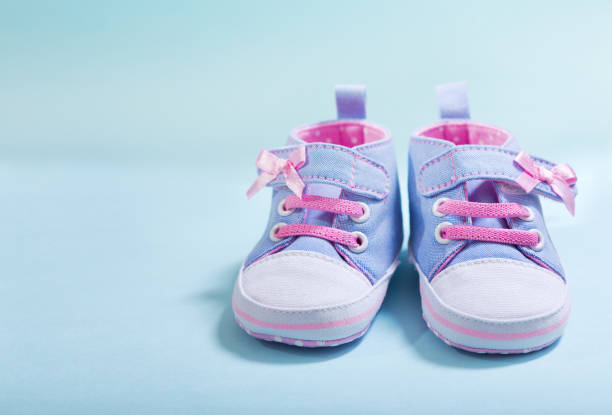 istock baby sneakers on blue background 979012700