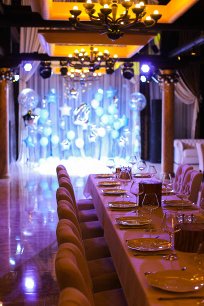 istock Served table with blue balloons on illuminated scene at restaurant 979016550