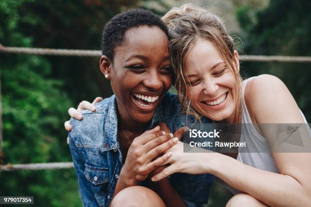 Happy Friends Holding Each Other Stock Photo - Download Image Now - Friendship, Women, Laughing