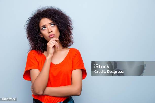 Portrait With Copy Space Empty Place Of Thoughtful Minded Woman With Modern Hairdo Holding Hand On Chin Looking Up Trying To Find Solution Isolated On Grey Background Stock Photo - Download Image Now