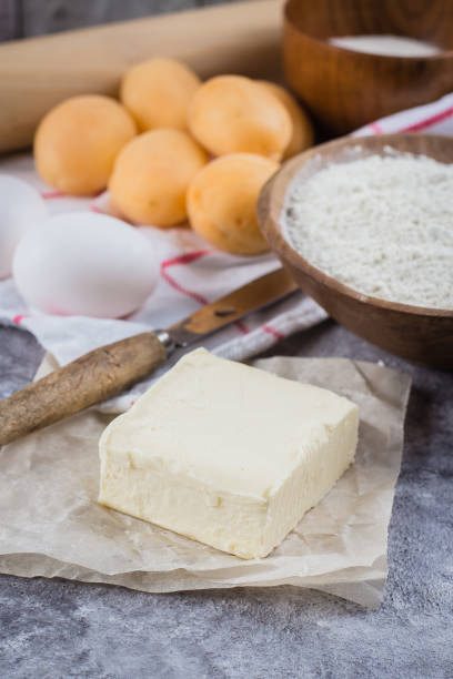 istock Baking ingredients for cake, pie, shortbread pastry: flour, eggs, sugar, butter, rolling pin and on gray concrete table background. Top view, copy space 979017430