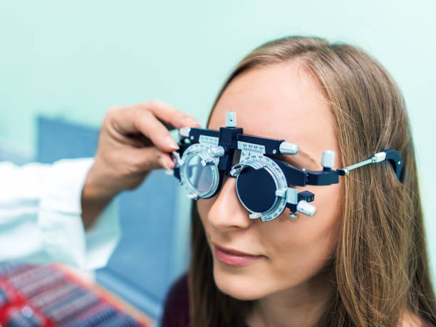 istock Young woman having her eyes checked at ophthalmologist 979017726