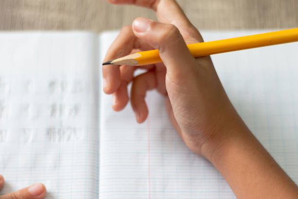 istock Hand is holding a yellow pencil with high angle 979026702