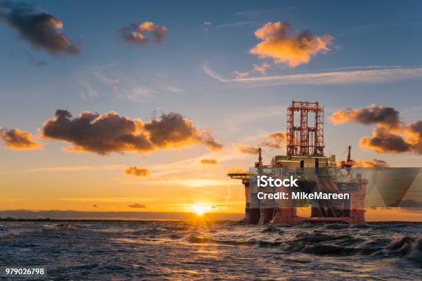 Offshore Oil Rig At Sunset Stock Photo - Download Image Now - Offshore Platform, Gasoline, Sea