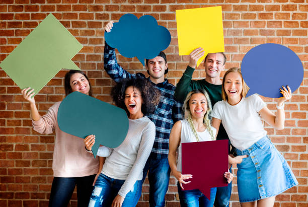 istock Happy young adults holding empty placard thought bubbles copyspace 979027116