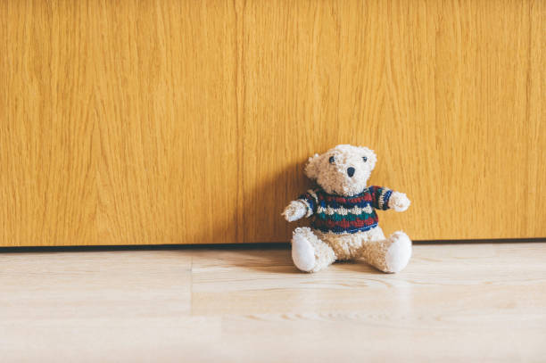 istock Single teddy bear on a floor in a child room 979027212