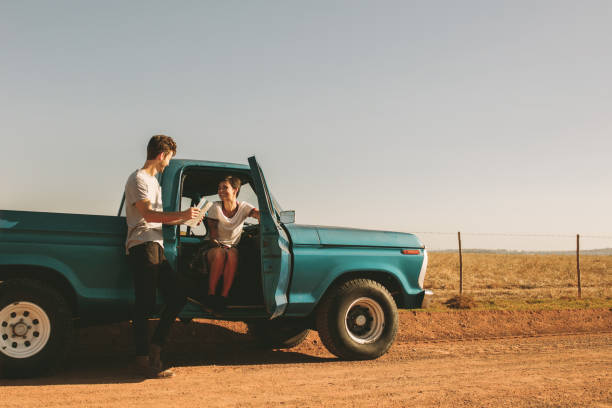 istock Couple on a road trip looking at map for navigation 979027984
